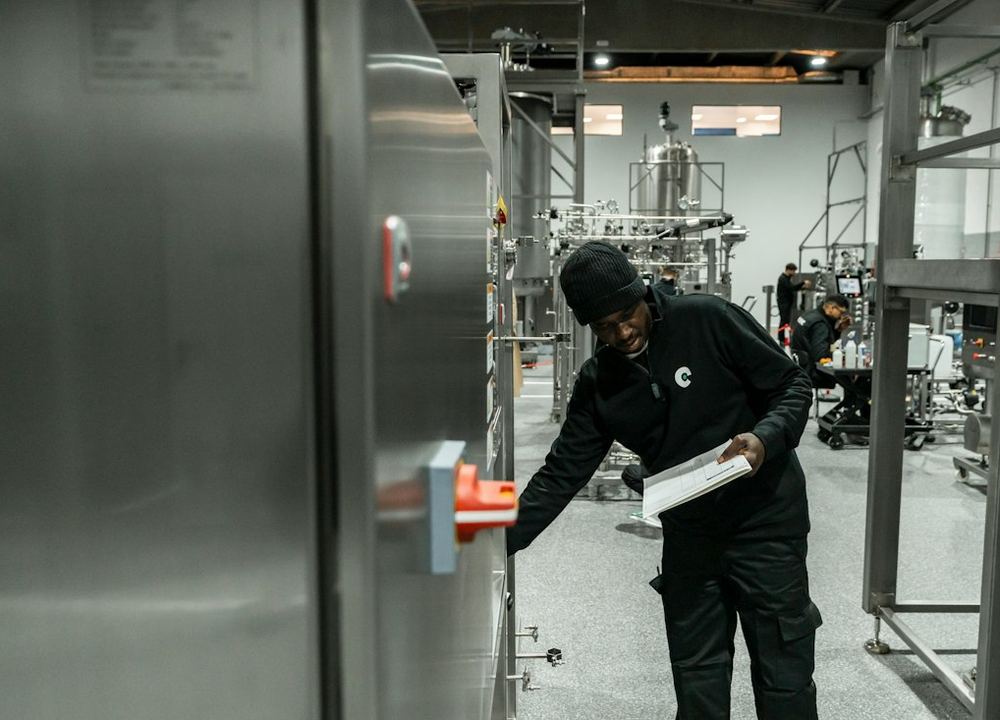 Technician inspecting process equipment during a GMP compliance check